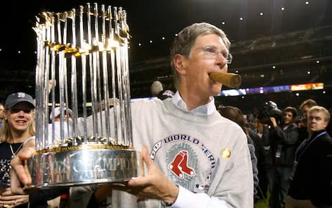 Red Sox owner John Henry holds the 2007 World Series trophy - Credit: Reuters
