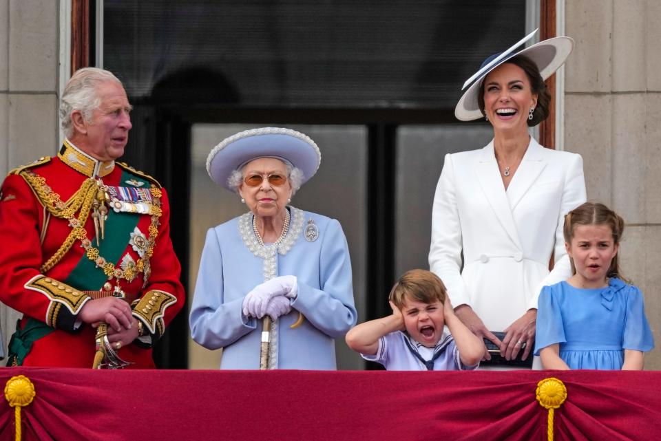 Prince Louis plugs his ears as he appears on the balcony of Buckingham Palace along with Prince Charles (from left), Queen Elizabeth II, Duchess Kate and Princess Charlotte during Platinum Jubilee festivities on June 2, 2022.