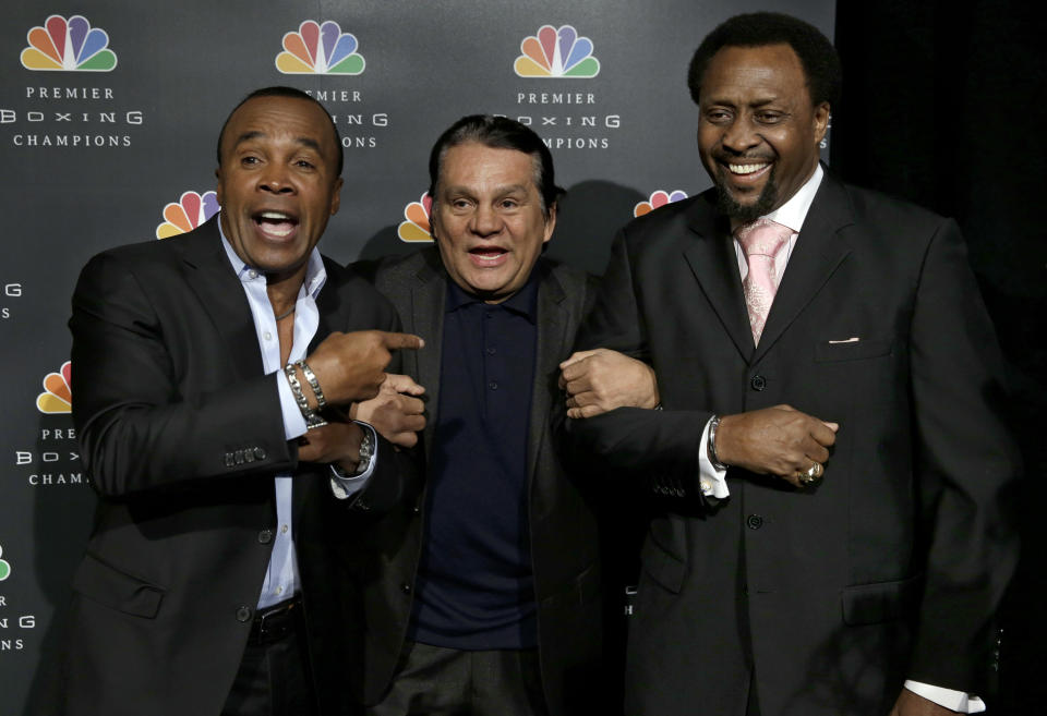 Boxing legends Sugar Ray Leonard, left, Roberto Duran, center, and Thomas Hearns joke around while posing for pictures during a news conference in New York, Wednesday, Jan. 14, 2015. NBC plans to air boxing matches on broadcast television beginning with an event on March 7, 2015. (AP Photo/Seth Wenig)