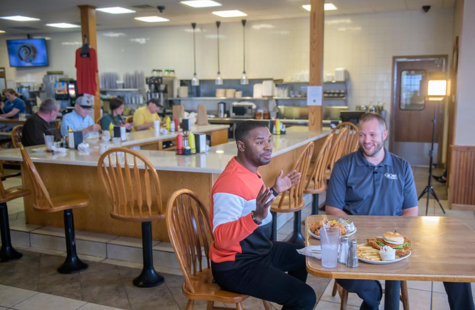 "America's Best Restaurants" host J Russell, left, chats with Derek Vollmer, owner of the Busy Corner, a local landmark restaurant at 302 Eureka Street in Goodfield, while filming an episode of the web show on Wednesday, March 13, 2024 in Goodfield.
(Credit: MATT DAYHOFF/JOURNAL STAR)