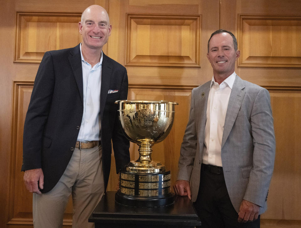 2024 Presidents Cup captains Mike Weir, right, for the international team, and Jim Furyk, for the U.S. team, pose for photos Tuesday, Sept. 12, 2023, at Royal Montreal Golf Club in Ile-Bizard, Quebec. (Ryan Remiorz/The Canadian Press via AP)