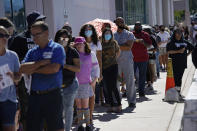 People wait in line at one of a few in person voting places during a nearly all-mail primary election Tuesday, June 9, 2020, in Las Vegas. (AP Photo/John Locher)