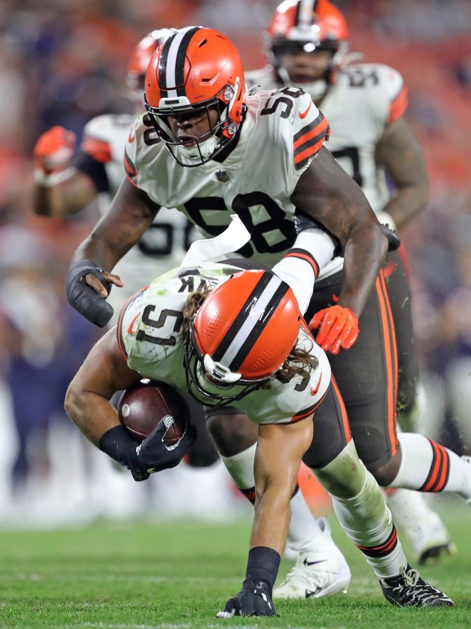 Cleveland Browns linebacker Jordan Kunaszyk (51) dives on a ball fumbled by Chicago Bears running back De'Montre Tuggle (30) during the second half of an NFL preseason football game, Saturday, Aug. 27, 2022, in Cleveland, Ohio.