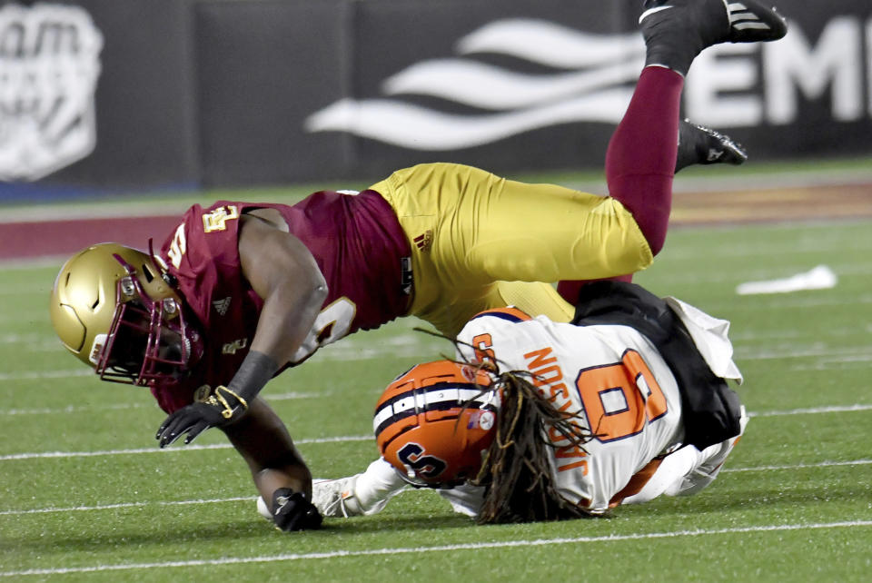 Boston College linebacker Kam Arnold falls over Syracuse running back Courtney Jackson on a tackle during the first half of an NCAA college football game Saturday, Nov. 26, 2022, in Boston. (AP Photo/Mark Stockwell)