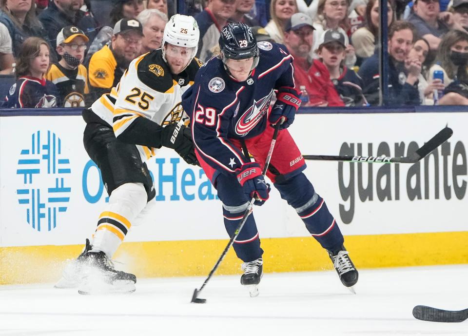 Columbus Blue Jackets left wing Patrik Laine (29) passes around Boston Bruins defenseman Brandon Carlo (25) during the second period of the NHL hockey game at Nationwide Arena in Columbus on March 5, 2022. 