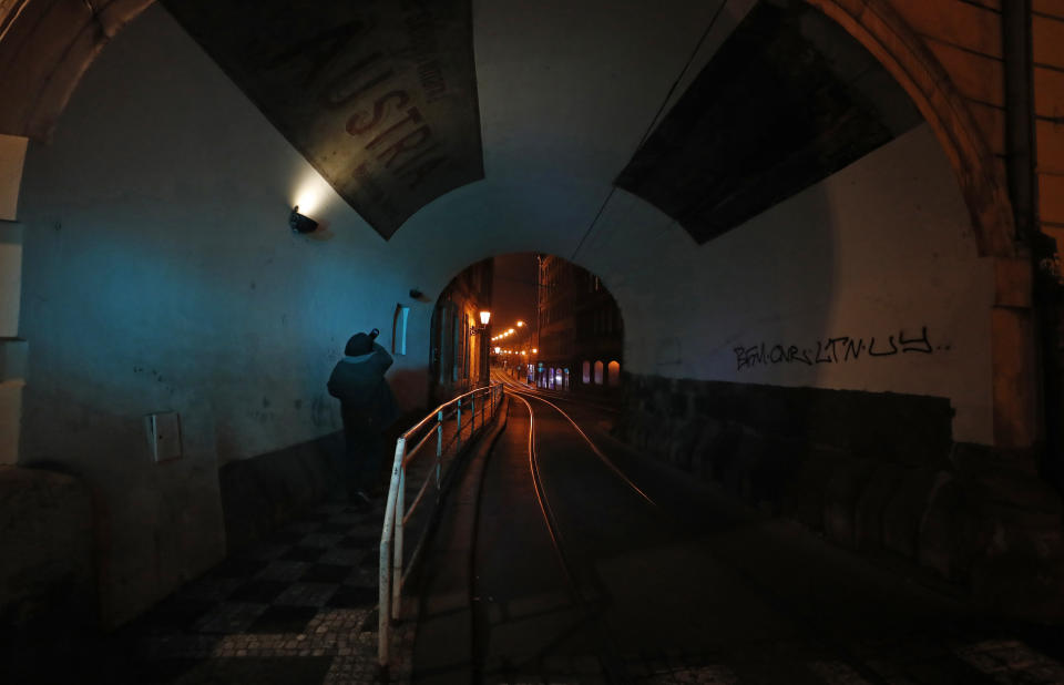 A man takes a sip from a bottle in Prague, Czech Republic, Friday, Jan 1, 2021. Due to the surge in coronavirus infections police boosted their presence across the country on New Year's Eve to enforce a night-time curfew starting at 9 p.m. and other strict restrictive measures imposed by the government that make it impossible to stage traditional New Year's celebrations. (AP Photo/Petr David Josek)