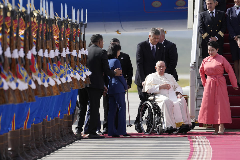 Pope Francis is received by the Foreign Minister of Mongolia, Batmunkh Battsetseg, right, as he arrives at Ulaanbaatar's International airport Chinggis Khaan, Friday, Sept. 1, 2023. Pope Francis is traveling to Mongolia to encourage one of the world's smallest and newest Catholic communities. It's the first time a pope has visited the Asian country and comes at a time when the Vatican's relations with Mongolia's two powerful neighbors, Russia and China, are once again strained. (AP Photo/Andrew Medichini)