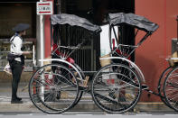 A rickshaw puller waits for tourists near Sensoji Temple in Asakusa district Thursday, Oct. 22, 2020, in Tokyo. (AP Photo/Eugene Hoshiko)