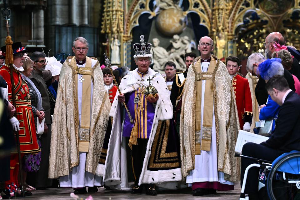 King Charles left Westminster Abbey wearing the Imperial State Crown while carrying the Sovereign's Orb and Sceptre. (Photo by BEN STANSALL/POOL/AFP via Getty Images)