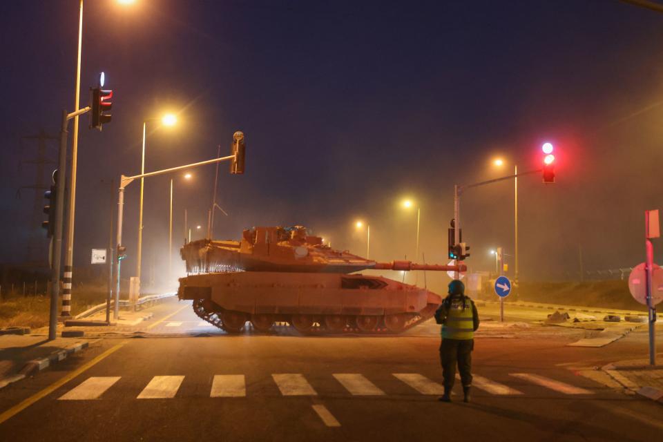 A convoy of Israeli armoured vehicles advances near the border with Gaza on October 12, 2023. Thousands of people, both Israeli and Palestinian, have died since October 7, after Palestinian Hamas militants entered Israel in a surprise attack leading Israel to declare war on Hamas in the Gaza Strip enclave. (Photo by Menahem KAHANA / AFP) (Photo by MENAHEM KAHANA/AFP via Getty Images)