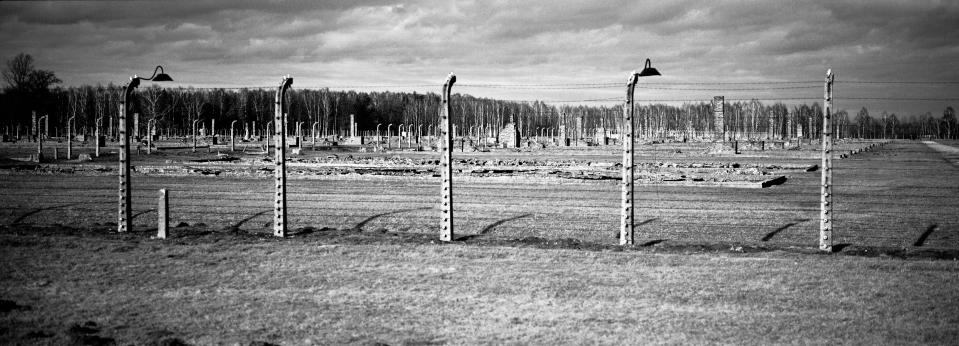 The remains of brick stone chimneys of prisoner barracks can be seen inside the former Nazi death camp of Auschwitz Birkenau or Auschwitz II. in Oswiecim, Poland, Sunday, Dec. 8, 2019. On Monday — 75 years after its liberation — hundreds of survivors from across the world will come back to visit Auschwitz for official anniversary commemorations. In advance of that, Associated Press photographer Markus Schreiber visited the site. Using a panoramic camera with analog film, he documented the remains of the camp in a series of haunting black and white photos. (AP Photo/Markus Schreiber)