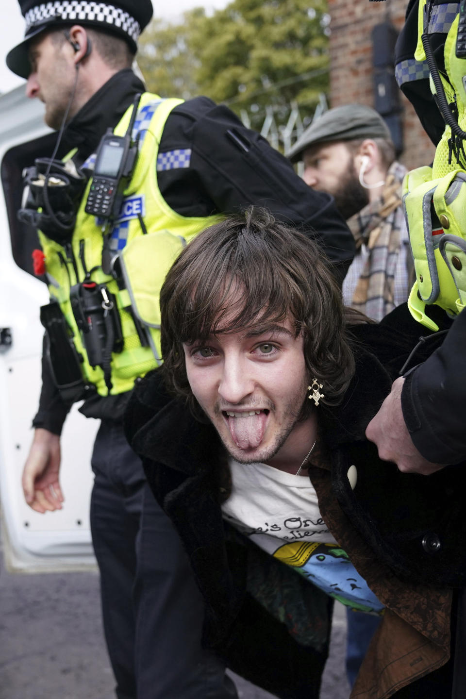 <p>Police detain a protester after he appeared to throw eggs at Britain's King Charles III and the Queen Consort as they arrived for a ceremony at Micklegate Bar, where the Sovereign is traditionally welcomed to the city, in York, England, Wednesday Nov. 9, 2022. (Jacob King/PA via AP)</p> 