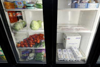 Produce, meat and eggs sit in a cooler at a local super market, Friday, May 29, 2020, in Des Moines, Iowa. As if trips to the grocery store weren't nerve-racking enough, shoppers lately have seen the costs of meat, eggs and even potatoes soar as the coronavirus has disrupted processing plants and distribution networks. (AP Photo/Charlie Neibergall)