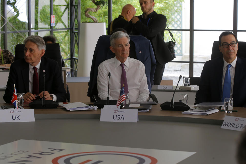 British Chancellor of the Exchequer Philip Hammond, left, Federal Reserve Chair Jerome Powell, center, and U.S Treasury Secretary Steve Mnuchin attend a working session at the G-7 Finance Wednesday July 17, 2019 in Chantilly, north of Paris. The Trump administration is objecting to France's plan to tax Facebook, Google and other U.S. tech giants, a rift that's overshadowing talks between seven longtime allies near Paris this week on issues ranging from digital currencies to trade. (AP Photo/Michel Euler)
