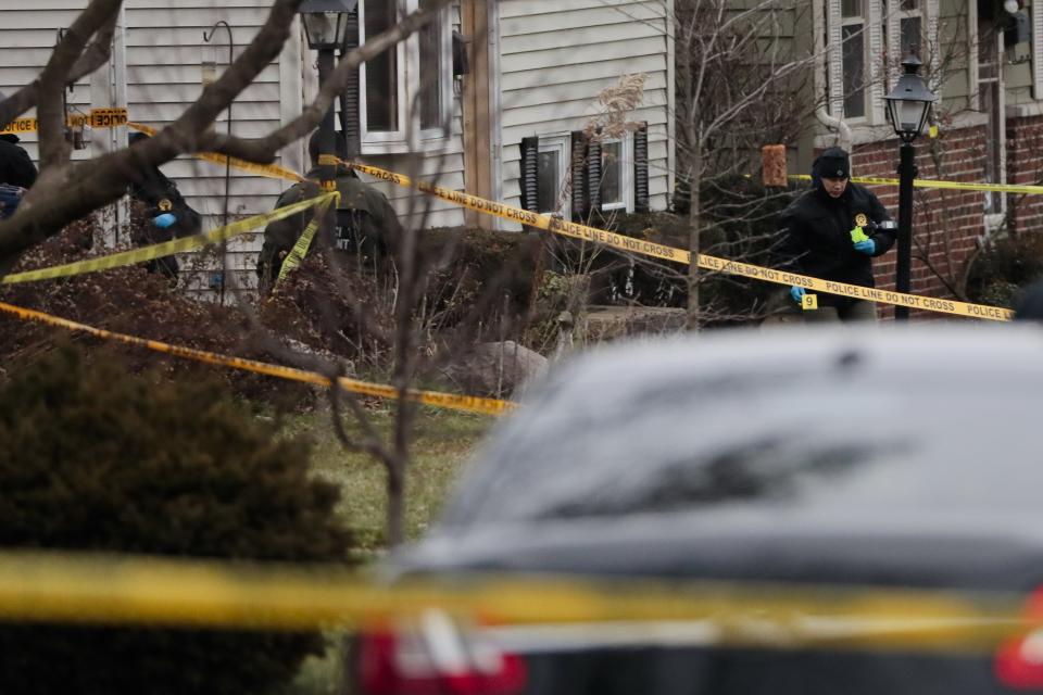 Agents from the Ohio Bureau of Criminal Investigation work the scene of a fatal shooting in Tuesday.
