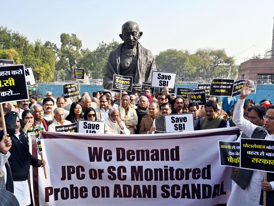 Opposition parties' MPs stage a protest over Adani row at the Gandhi statue, in the Parliament complex, on February 6, 2023 in New Delhi, India.