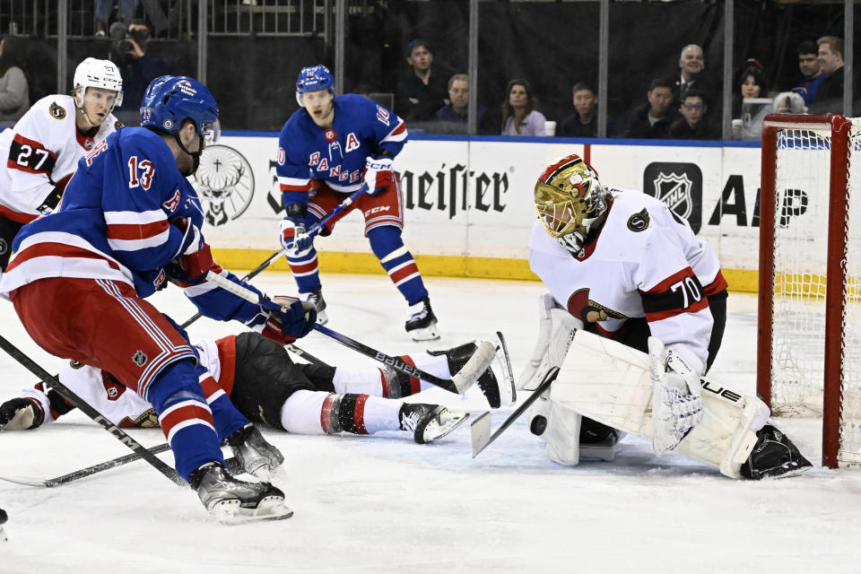 Ottawa Senators goaltender Joonas Korpisalo (70) stops a shot by New York Rangers left wing Alexis Lafrenière (13) during the second period of an NHL hockey game Monday, April 15, 2024, at Madison Square Garden in New York. (AP Photo/Bill Kostroun)