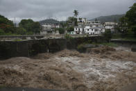 The swollen Los Esclavos River flows violently during tropical storm Amanda in Cuilapa, eastern Guatemala, Sunday, May 31, 2020. The first tropical storm of the Eastern Pacific season drenched parts of Central America on Sunday and officials in El Salvador said at least seven people had died in the flooding. (AP Photo/Moises Castillo)