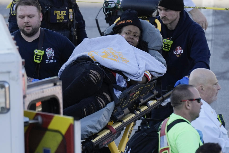 A person is taken to an ambulance following a shooting at the Kansas City Chiefs NFL football Super Bowl celebration in Kansas City, Mo., Wednesday, Feb. 14, 2024. Multiple people were injured, a fire official said. (AP Photo/Charlie Riedel)