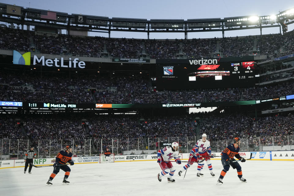 The New York Rangers play the New York Islanders during the second period of an NHL Stadium Series hockey game in East Rutherford, N.J., Sunday, Feb. 18, 2024. (AP Photo/Seth Wenig)