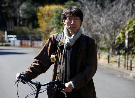 Yuya Kamoshita, wearing a small anti-nuclear banner on a shoulder strap of his bag, poses during an interview with Reuters in Tokyo, Japan, March 8, 2017. REUTERS/Kim Kyung-Hoon