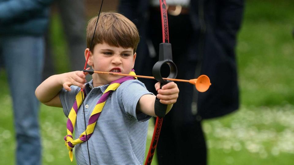 PHOTO: Prince Louis of Wales tries his hand at archery while taking part in the Big Help Out, during a visit to the 3rd Upton Scouts Hut in Slough, west of London on May 8, 2023. (Daniel Leal/POOL/AFP via Getty Images)