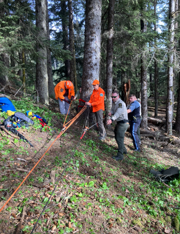 Rescue workers work to retrieve a California Bay Area man who died after falling more than 300 feet off a cliff this week hiking with his wife in Curry County, Oregon.