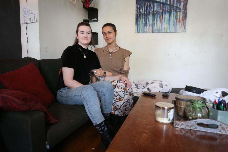 Andy Rodenbusch, left, and Nathalie "Hal" Dempsey pose for a portrait in living room in Springfield on Friday, April 21, 2023. Rodenbusch, Dempsey and their third partner are raising money to move out of Missouri following Attorney General Andrew Bailey's emergency rule on gender-affirming care.