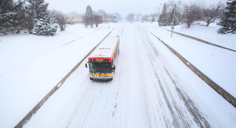 A CyRide bus passes along an empty Grand Avenue during a winter storm on Friday, Jan. 12, 2024, in Ames, Iowa.
