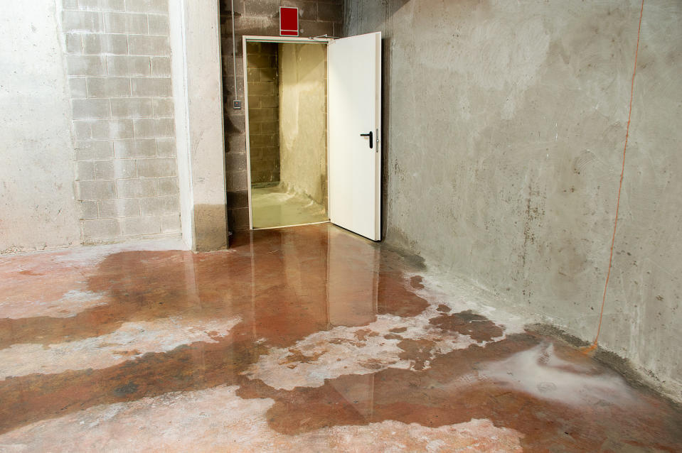 Leaking basement walls with water all over the floor.