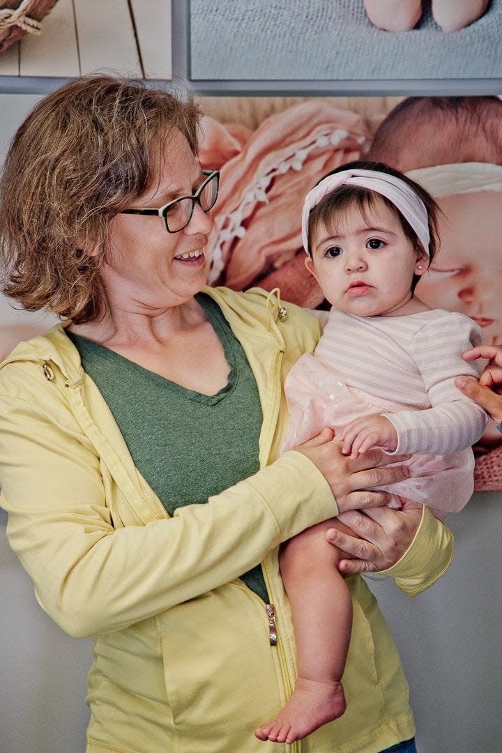 Nurse midwife Caitlin Hainley with one of her patients' infant children. Hainley and fellow midwife Emily Zambrano-Andrews are suing the state to challenge what they say is an unconstitutional permitting process to be allowed to build a standalone birth center in Des Moines.