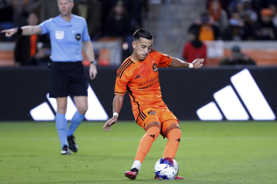 Houston Dynamo midfielder Amine Bassi scores on a penalty kick against Austin FC during the second half of an MLS soccer match Saturday, March 18, 2023, in Houston. (AP Photo/Michael Wyke)