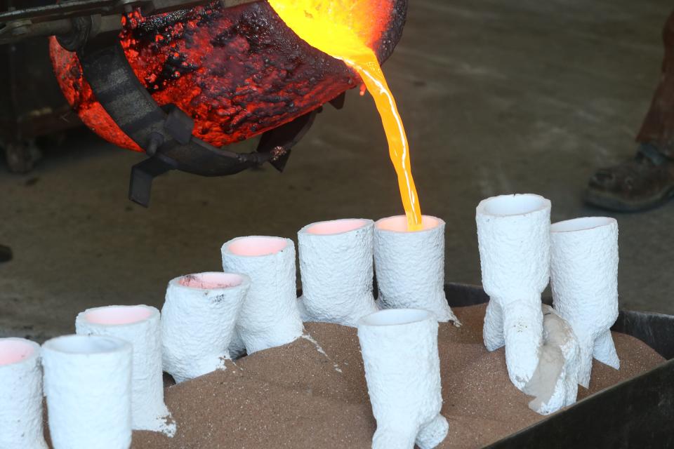 Molten bronze pours into molds that will eventually be welded together to become an 8-foot statue of Obie.