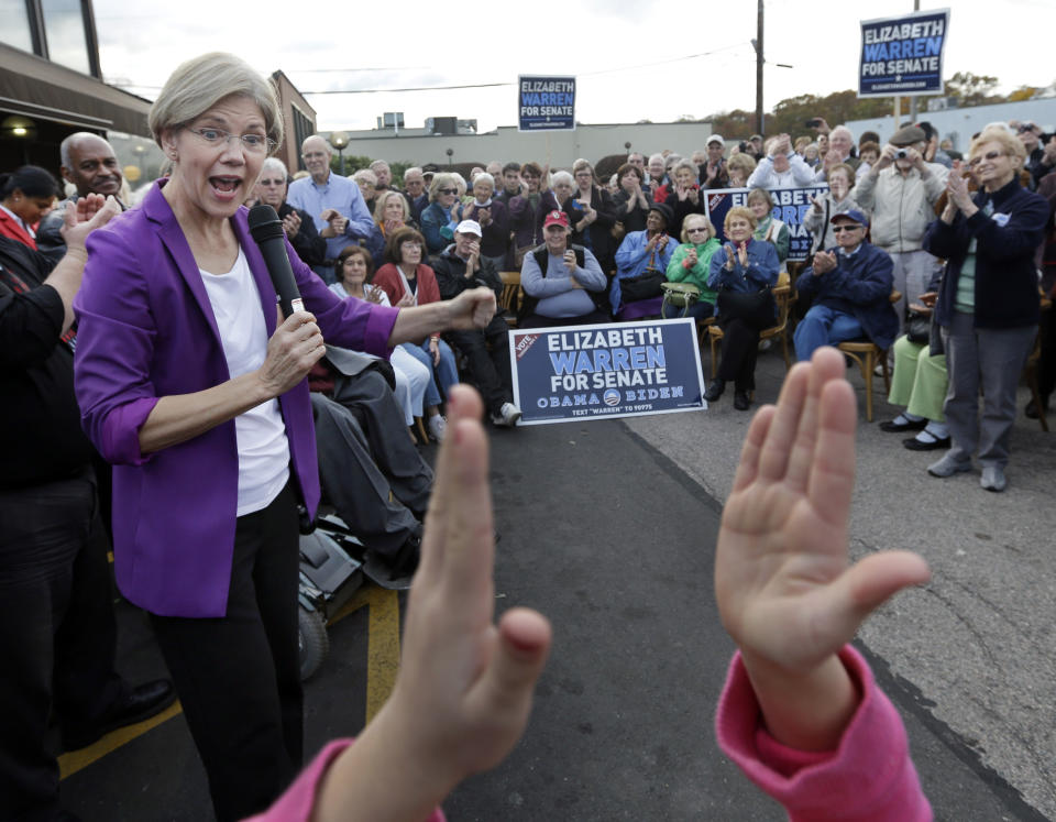 Democratic candidate for U.S. Senate Elizabeth Warren, left, reacts as she is applauded during her campaign speech in Brockton, Mass., Thursday, Nov. 1, 2012. Warren is challenging Republican incumbent Sen. Scott Brown. (AP Photo/Elise Amendola)