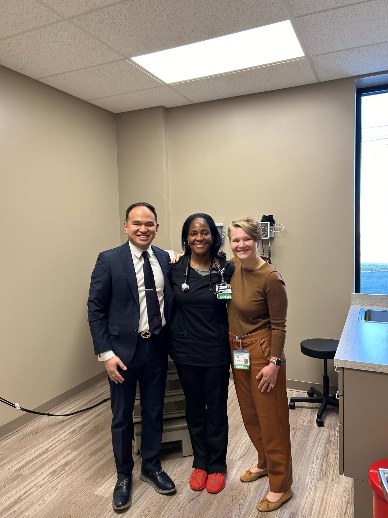 Juan-Paulo Afable, chief executive officer of My Community Health Center, left, nurse practitioner LaToya Dickens-Jones and Dr. Sarah Hoehnen stand inside an exam room at My Community Health Center's new clinic at Southeast Market Plaza at 1318 Gonder Ave. SE in Canton.