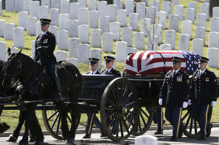 FILE PHOTO: The caisson and casket are seen in procession before a burial service for U.S. Army Sergeant First Class Matthew McClintock, who was killed in action in Afghanistan in January, at Arlington National Cemetery in Virginia March 7, 2016. REUTERS/Gary Cameron/File Photo