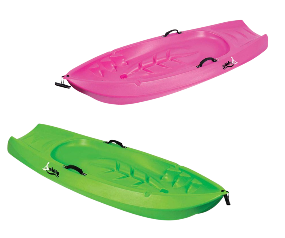 A green and pink plastic kids kayak against a white background.