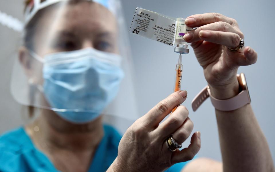 Nurse Joan Love prepares the AstraZeneca vaccine at the Aviva Stadium mass vaccination centre in Dublin, Ireland - CLODAGH KILCOYNE/REUTERS