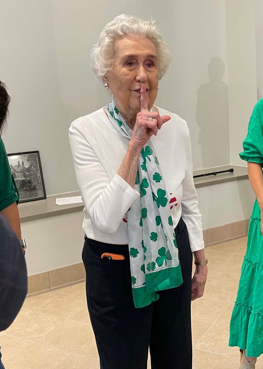 Helen Mabry Connor shares a secret with the crowd at a reception celebrating the 90th school year of Knoxville Catholic High School on Tuesday, Aug. 9, 2022.