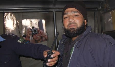 Malik Mumtaz Hussain Qadri, a bodyguard who killed Punjab governor Salman Taseer, is photographed after being detained at the site of Taseer's shooting in Islamabad, in this January 4, 2011 file picture. REUTERS/Saaf-ur-Rahman/Files