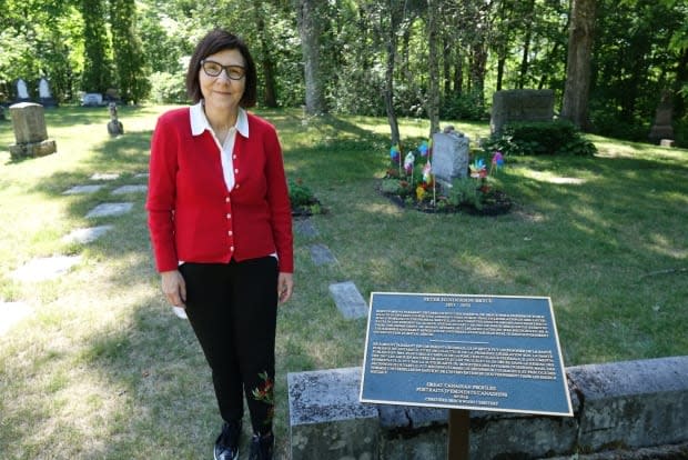 Cindy Blackstock stands near Dr. Peter Bryce's grave at Beechwood Cemetery in Ottawa. 'People think it’s about erasing the white history. It’s not. It’s about telling the story of the people of that period — the people who did the right things for the right reasons, and those who chose to do the wrong thing.' (Giacomo Panico/CBC - image credit)