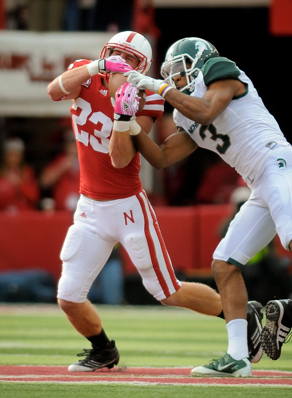 LINCOLN, NE - OCTOBER 29: Defensive back Lance Thorell #23 of the Nebraska Cornhuskers takes the ball away from wide receiver B.J. Cunningham #3 of the Michigan State Spartans during their game at Memorial Stadium October 29, 2011 in Lincoln, Nebraska. (Photo by Eric Francis/Getty Images)