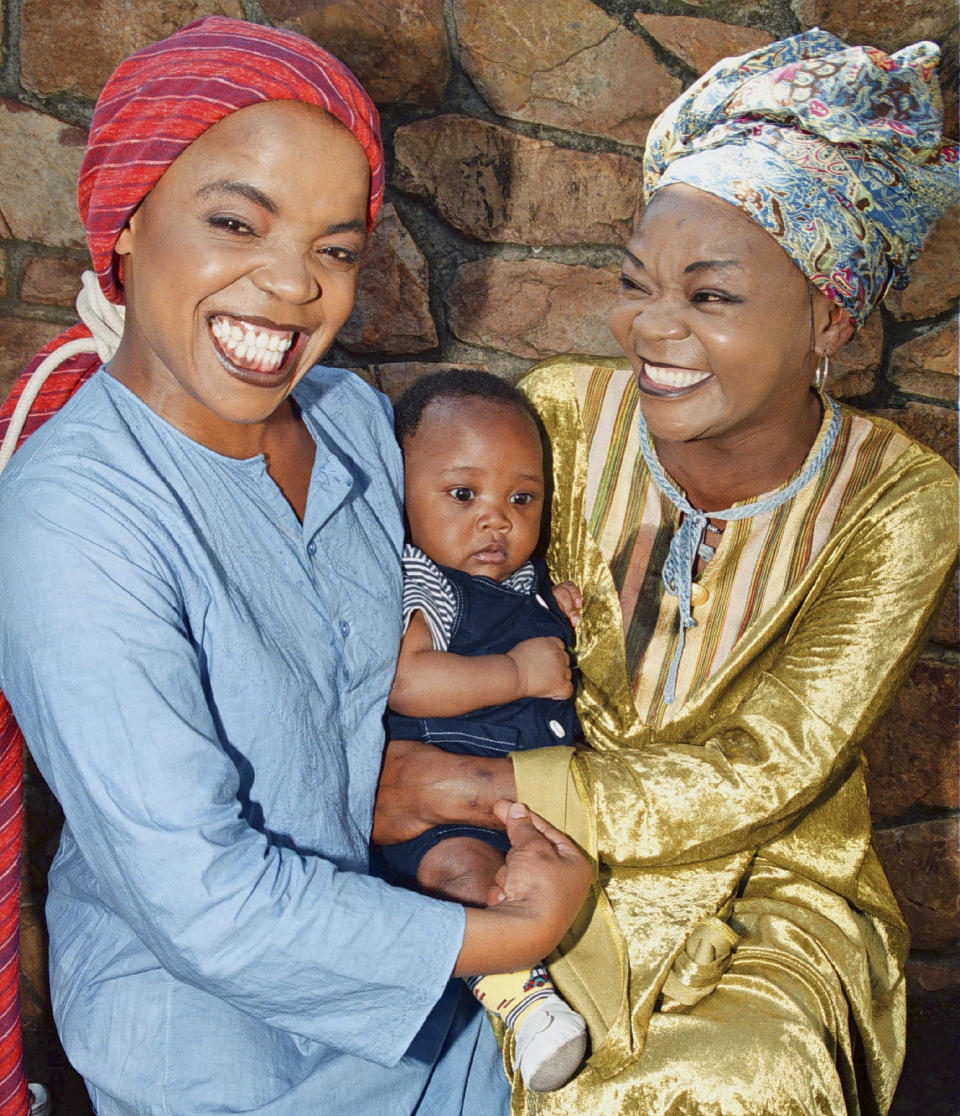 Music legends, Brenda Fassie and Rebecca Malope hold a baby together.
