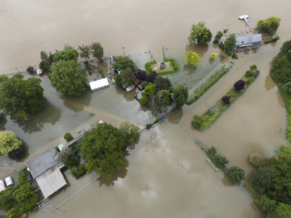 The Rhine river overflowed its banks in Hattenheim, Germany, Monday, June 3, 2024. The death toll in floods across a large part of southern Germany rose to two on Monday as the body of a missing woman was found. Chancellor Olaf Scholz visited the flooded region and officials warned that water levels could rise further in some areas. (Boris Roessler/dpa via AP)