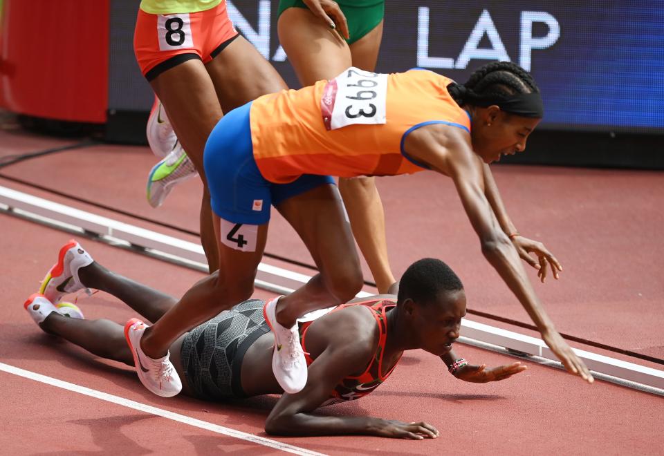 The Netherlands' Sifan Hassan (4) and Kenya's Edinah Jebitok trip and fall during their 1,500-meter heat at the Tokyo Olympics.