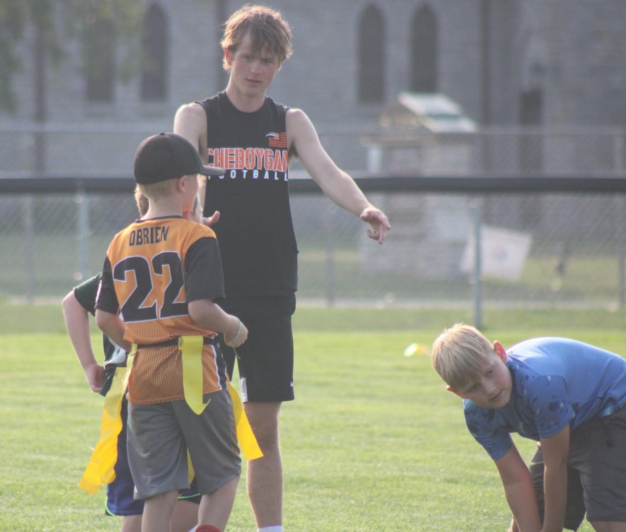 Cheboygan senior football player Kaleb Goodrich was among those Chiefs who worked with campers during Monday's youth football camp session.