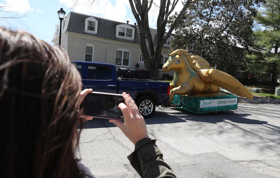 Kristen Myers shoots video of the Kentucky Derby Festival Zoeller Pump Touring Parade on Saturday, April 1, 2023 as it passes through Beechwood Village.