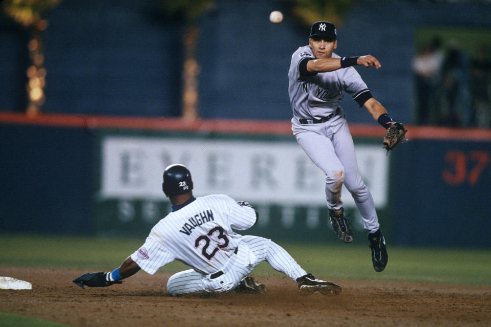 Yankees shortstop Derek Jeter turns a double play during the 1998 World Series.