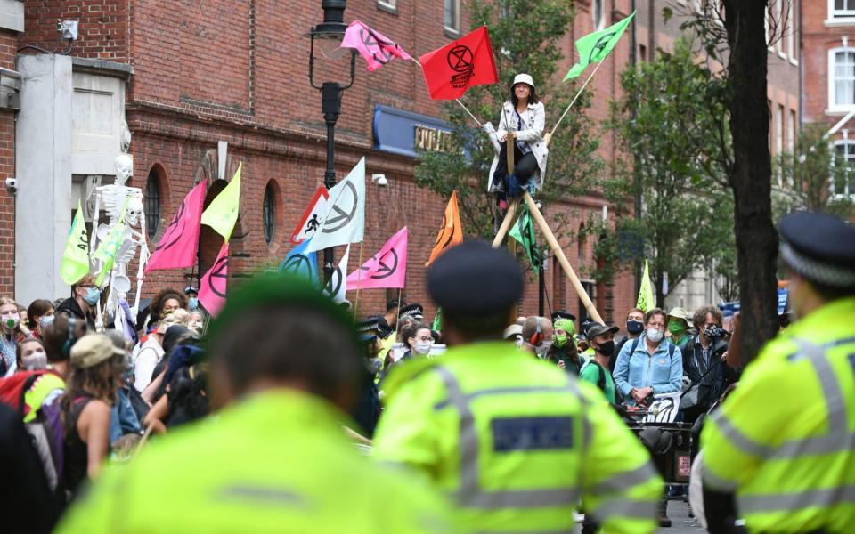 Extinction Rebellion protesters blocked Tufton Street in Westminster, which they claim is home to 'shadowy think tanks'  - PA