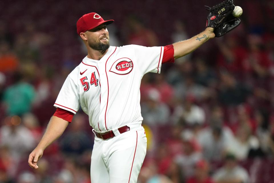 Cincinnati Reds relief pitcher Hunter Strickland (54) smiles as he receives the ball before throwing his first pitch of the game in the ninth inning of a baseball game against the Boston Red Sox, Tuesday, Sept. 20, 2022, at Great American Ball Park in Cincinnati.